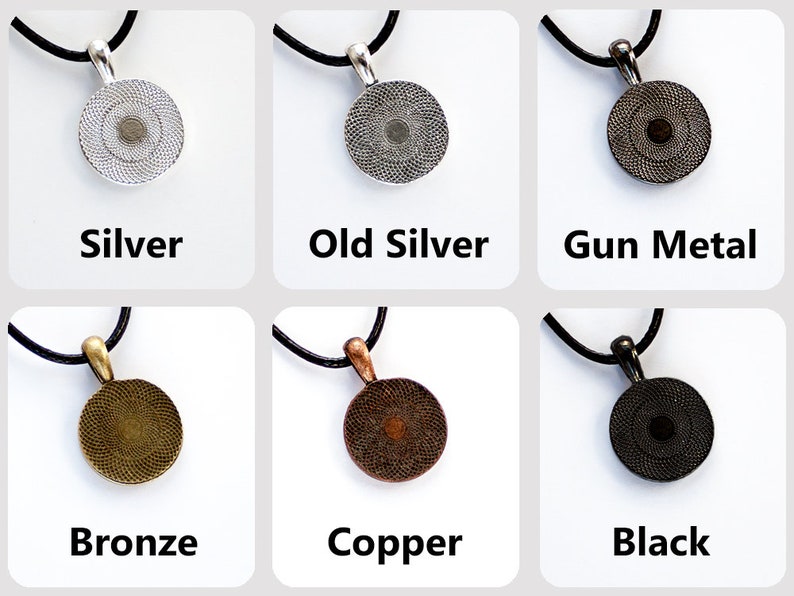 May include: Six round pendants with different finishes: silver, old silver, gun metal, bronze, copper, and black. Each pendant is on a black cord.
