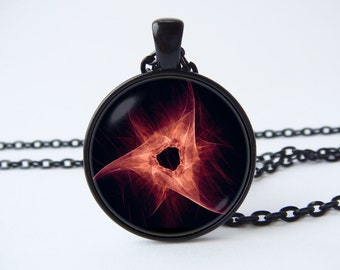 May include: A black chain necklace with a round pendant featuring a red and orange abstract design with a black center.