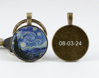May include: A round, bronze-colored keychain with a glass insert featuring a painting of Vincent van Gogh's "Starry Night". The back of the keychain is engraved with the date "08-03-24".