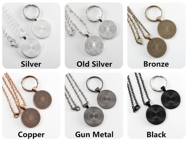 May include: Six different color variations of a round pendant necklace and keychain set. The pendant is a circle with a textured design. The necklace and keychain are made of metal chains. The colors are silver, old silver, bronze, copper, gun metal, and black.