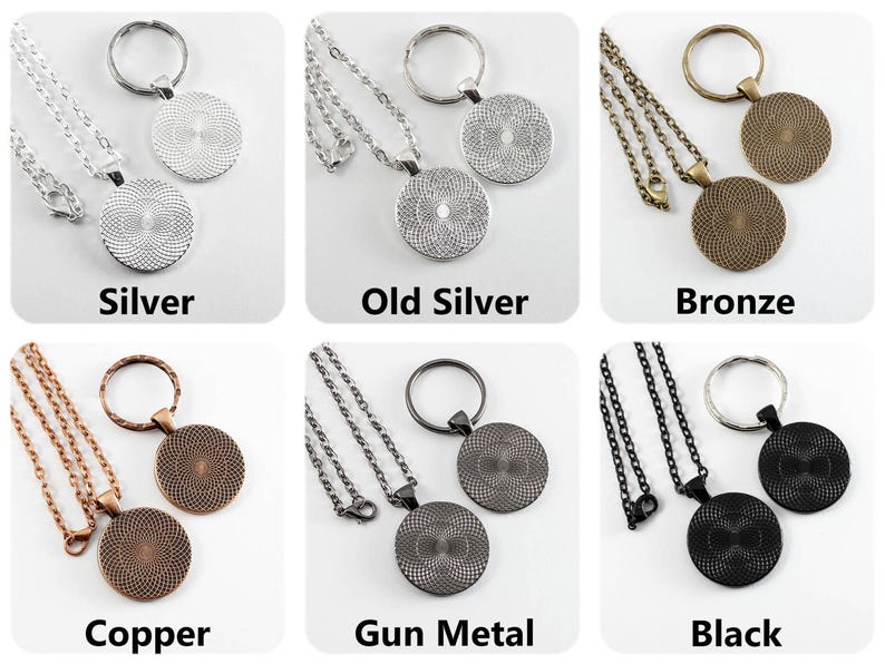 May include: Six different color variations of a necklace and keychain set. The set includes a silver, old silver, bronze, copper, gun metal, and black chain with a round pendant. Each chain has a matching key ring.