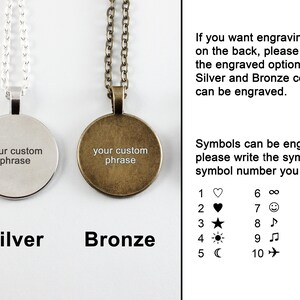 May include: Two round silver and bronze pendants with chains. The pendants have the text "your custom phrase" engraved on them. The image also shows a list of symbols that can be engraved on the back of the pendants.