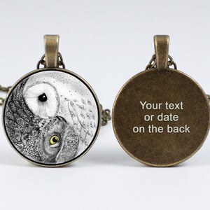 May include: A silver necklace with a round glass pendant featuring a black and white yin yang design with an owl on each side. The back of the pendant is plain with the text "Your text or date on the back".