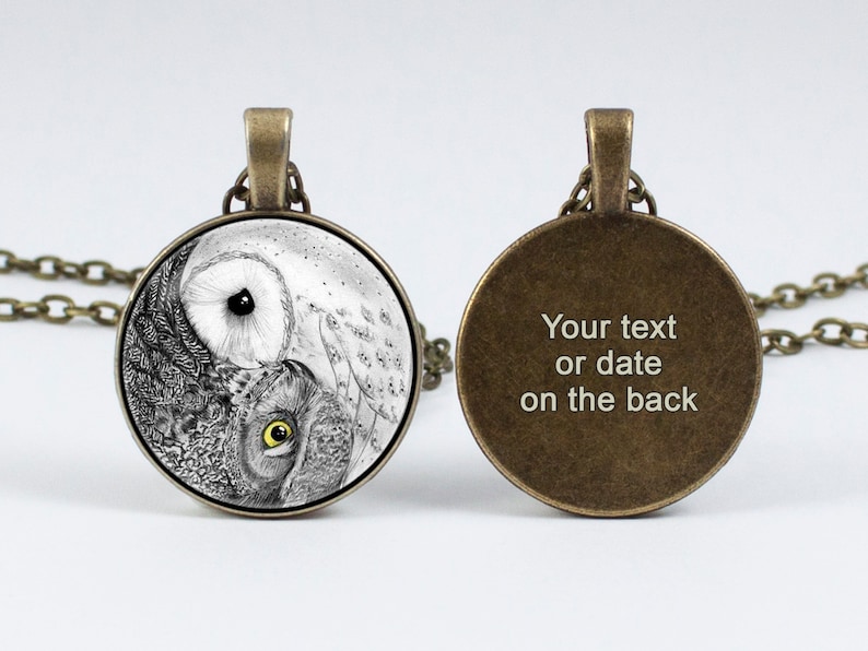 May include: A silver necklace with a round glass pendant featuring a black and white yin yang design with an owl on each side. The back of the pendant is plain with the text "Your text or date on the back".