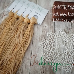 May include: Five spools of light brown embroidery floss labeled "Ginger Snap" and "Matt base thread DMC 436-437".