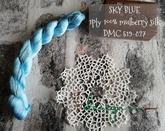 May include: A skein of sky blue 1 ply 100% mulberry silk thread, DMC 519-827, on a white surface with a white lace doily.