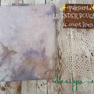 May include: A piece of off-white linen fabric with a brown and purple tie-dye pattern. The fabric is labeled "opalescent LAVENDER BOUQUET 36 count linen".