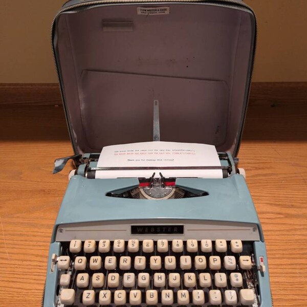 1966 light teal Webster portable manual typewriter with carrying case