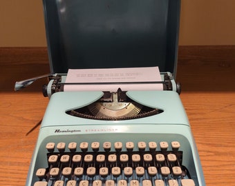 1970's aqua blue Remington Streamliner portable typewriter
