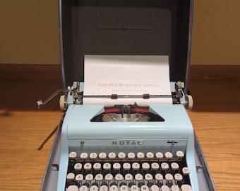 1956 bubble gum pink  Royal Quiet Deluxe portable manual typewriter with carrying case