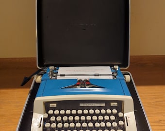 1973 Blue Royal Custom III portable manual typewriter with carrying case