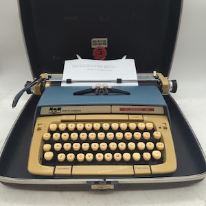 Cursive! 1972 Blue Smith Corona Classic 12 portable typewriter carrying case with script typeface