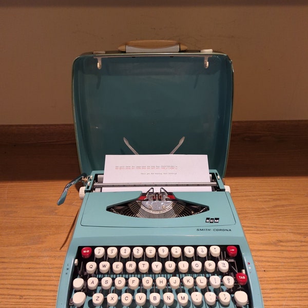 1970's turquoise Smith Corona Cougar ultra portable typewriter