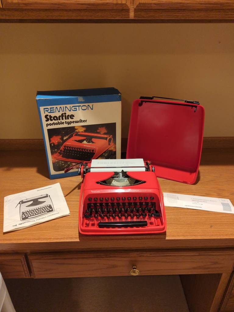 1960's Red Remington Starfire Portable Typewriter With 1960's Red Remington Starfire Portable Typewriter With