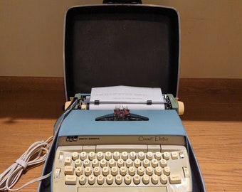 1960's Blue Smith Corona Coronet portable electric typewriter with carrying case