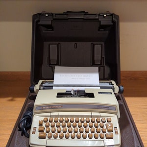 1970's brown Smith Corona DeVille electric portable typewriter with case