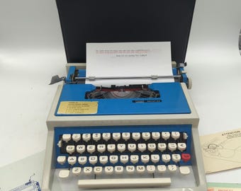 1970's Montgomery Wards Escort 44 portable manual typewriter with carrying case and original paperwork - Olivetti Lettera 31 clone