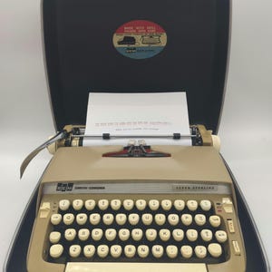 1967 Beige Smith Corona Super Sterling portable typewriter with case