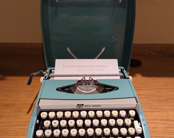 1970's turquoise Smith Corona Corsair Deluxe ultra portable typewriter