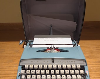 1966 light teal Wizard Truetype portable manual typewriter with carrying case