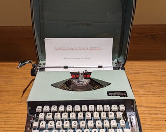 1970's Mint Green Morse 900 portable manual typewriter with carrying case.