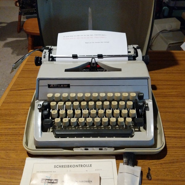 1971 Adler J2 portable typewriter with case, key, and manual