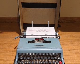 1960 light teal Olivetti Lettera 22 portable typewriter with case