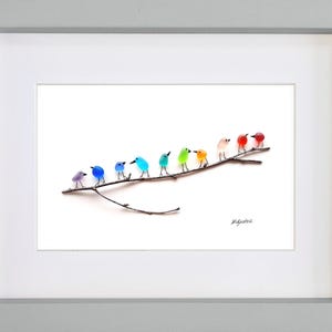 May include: A framed art print featuring a row of colorful glass birds perched on a brown branch. The birds are in shades of purple, blue, green, orange, and red. The artwork is set against a white background.