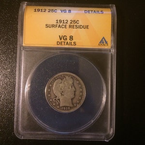May include: A 1912 quarter dollar coin in a plastic coin holder with a yellow label that reads "1912 25C SURFACE RESIDUE VG 8 DETAILS" and a blue label that reads "ANACS".