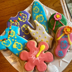 Summertime theme cookies.   Beach balls, palm trees, swimsuit, Hawaiian shirt, flower, flip flop, surfboard cookies
