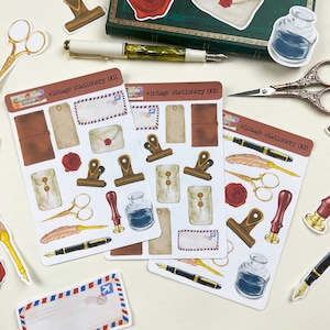 May include: Three sheets of vintage stationery stickers featuring illustrations of envelopes, pens, inkwells, and other stationery items. The stickers are labeled "vintage stationery 001", "vintage stationery 002", and "vintage stationery 003".