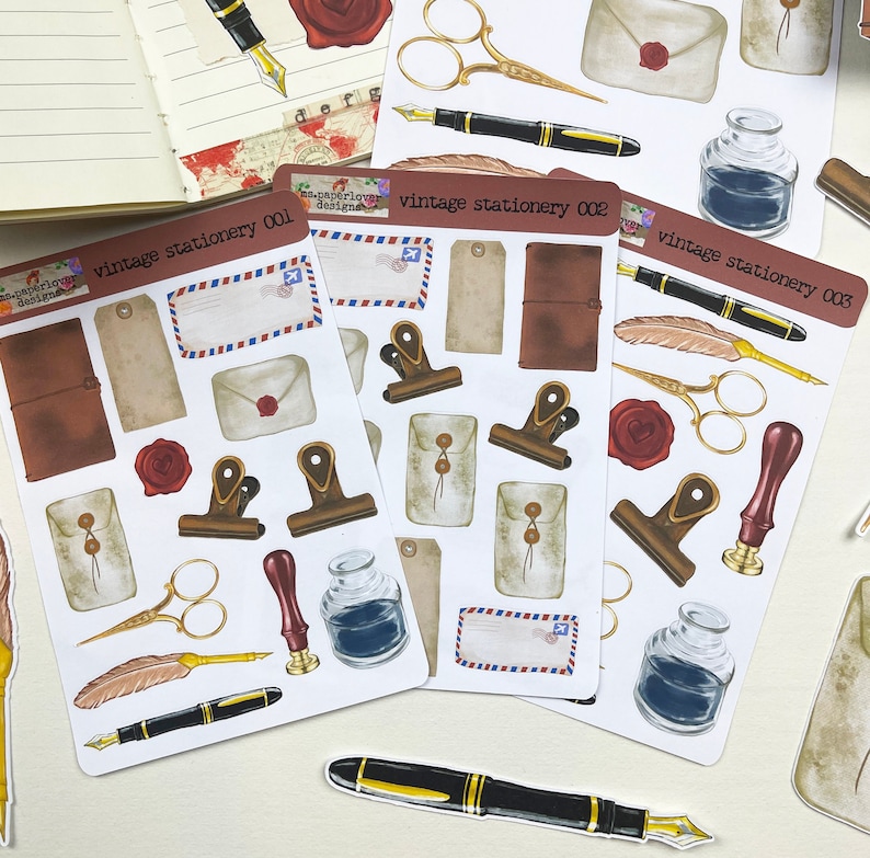 May include: Three sheets of vintage stationery stickers featuring illustrations of envelopes, pens, inkwells, feathers, and other stationery items. The stickers are labeled "vintage stationery 001", "vintage stationery 002", and "vintage stationery 003".