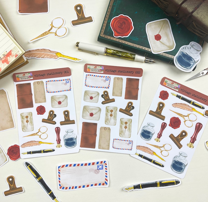 May include: A set of three sheets of vintage stationery stickers featuring illustrations of envelopes, stamps, pens, inkwells, and other stationery items. The stickers are labeled "vintage stationery 001", "vintage stationery 002", and "vintage stationery".