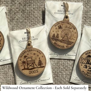 Puede incluir: Adornos navide&ntilde;os de madera con dise&ntilde;os grabados con l&aacute;ser. Cada adorno redondo muestra "Merry Christmas" y "Wildwood, NJ" con diferentes ilustraciones festivas. Est&aacute;n empaquetados en papel blanco y atados con hilo.