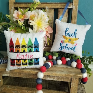 Handmade embroidered personalized back to school, crayons, mini pillows for tier trays, door hangers and teacher gifts