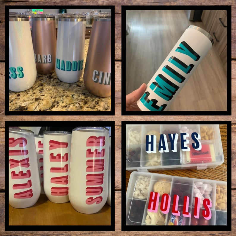 Op de afbeelding: Een verzameling gepersonaliseerde roestvrijstalen bekers en een snackbox. De bekers zijn in verschillende kleuren, waaronder wit, ros&eacute;goud en zilver, elk met een naam in vette letters. De snackbox is verdeeld in compartimenten met namen.