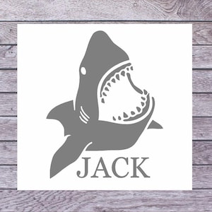 May include: A gray shark with its mouth open, with the name "JACK" printed below it.