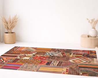 May include: A rectangular patchwork rug with a variety of geometric and abstract patterns in shades of red, orange, brown, and beige. The rug is placed on a white floor, with a woven basket and a vase with dried plants in the background.