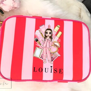May include: Pink and red striped makeup bag with a cartoon illustration of a woman wearing pyjamas and surrounded by makeup products. The bag has the name "LOUISE" printed on the front.