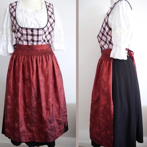May include: A traditional dirndl dress with a red and white plaid bodice, a red skirt with floral embroidery, and a black apron.