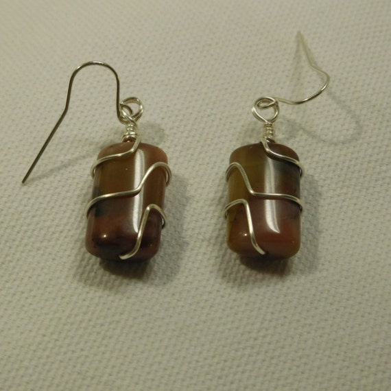 Wire wrapped stone dangle earrings. Silver wire and carmal colored stone. Barrel shaped drop earrings.