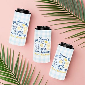 May include: Three white and light blue checkered can coolers with black tops. Each cooler has the text "She Found Her main squeeze Olivia's Bachelorette" with illustrations of lemons, bows, and a person running.