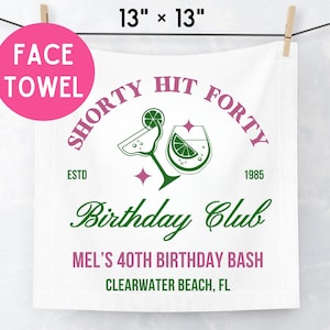 May include: A white 13 inch by 13 inch face towel featuring the text Shorty Hit Forty, Estd 1985, Birthday Club, Mel's 40th Birthday Bash, and Clearwater Beach, FL, with green and pink graphics of a margarita glass and a cocktail glass.