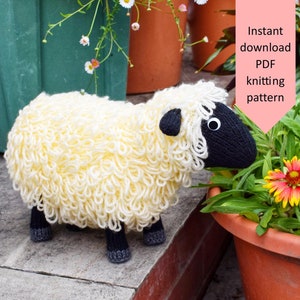 May include: A knitted white sheep with black eyes and a black nose, standing on a stone step, looking at a pot of flowers. Instant download PDF knitting pattern.