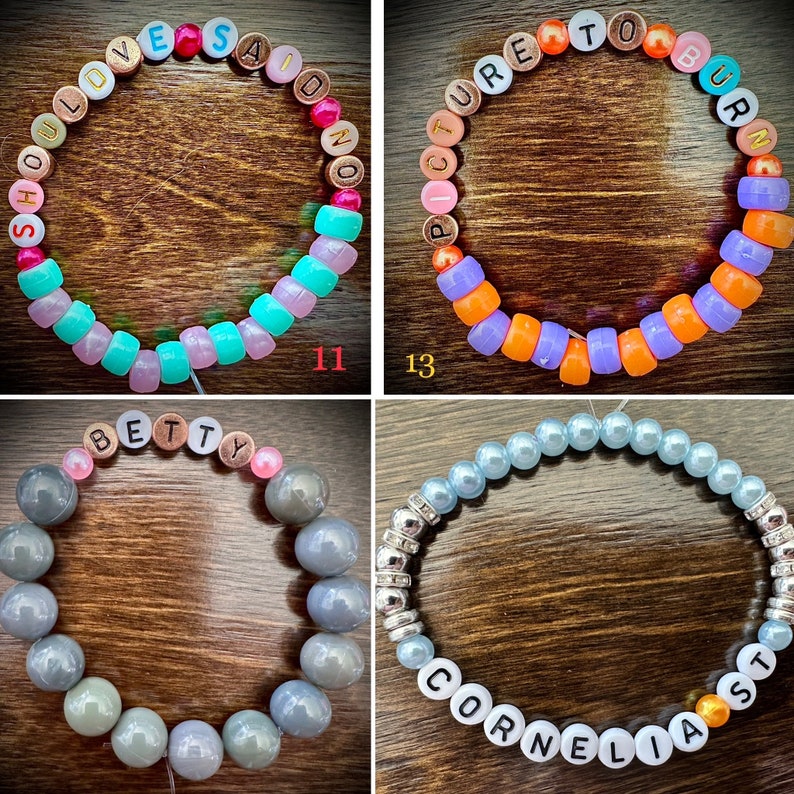 May include: Four colorful beaded bracelets with different names spelled out on them. The bracelets are made with colorful plastic beads and letter beads. The names on the bracelets are "SHOULDVE SAID NO", "PICTURE TO BURN", "BETTY", and "CORNELIA".