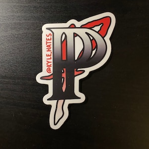 May include: A white sticker with a black and red stylized letter "P" with the text "@KYLE_HATES" on the left side.
