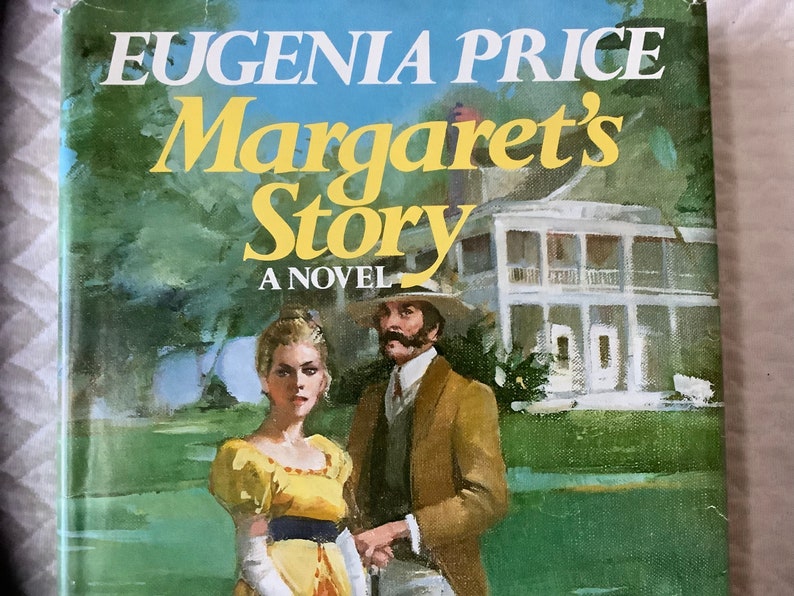 May include: A book cover with a painting of a couple standing in front of a white house. The title of the book is "Eugenia Price Margaret's Story A Novel".
