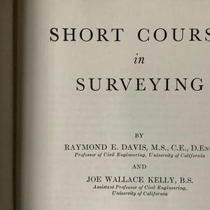May include: An open book page with the title "SHORT COURSE in SURVEYING" in large, bold, black font. The author's names and titles are listed below the title. The book is open on a white page.