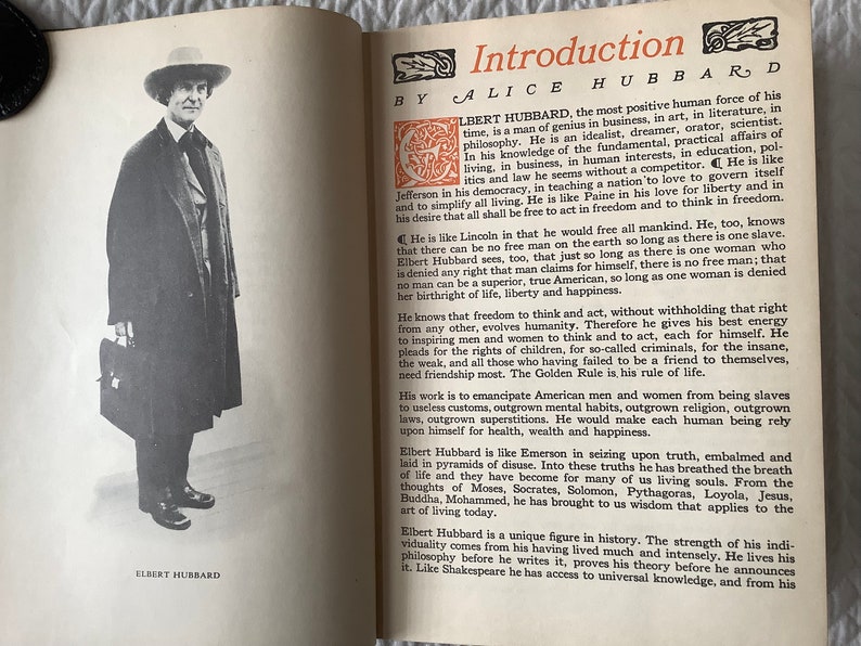May include: A black and white photo of Elbert Hubbard, a man wearing a hat and coat, standing next to a bookshelf. The text "Introduction by Alice Hubbard" is visible at the top of the page. The text "Elbert Hubbard" is visible at the bottom of the page.