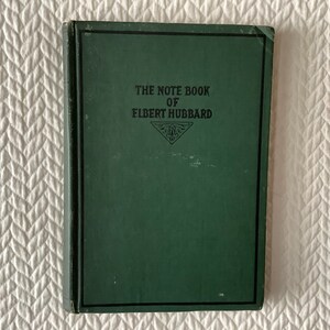 May include: A green hardcover book with the title "The Note Book of Elbert Hubbard" printed on the front cover.